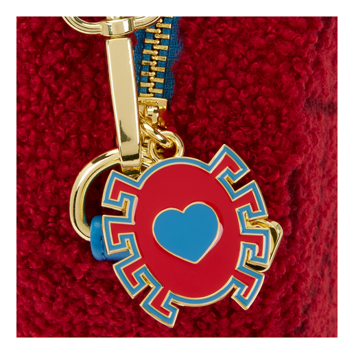 Keychain with red and blue heart design on a red textured background