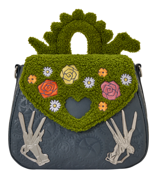 Handbag with green floral top section and gray bottom section featuring skeleton hands on a white background