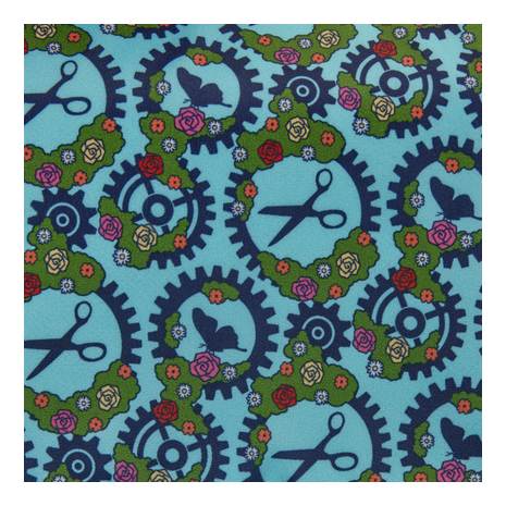 Patterned fabric with scissors, gears, and flowers on a blue background