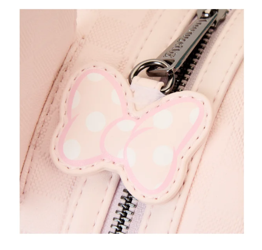 Pink butterfly charm on a pink bag with a zipper